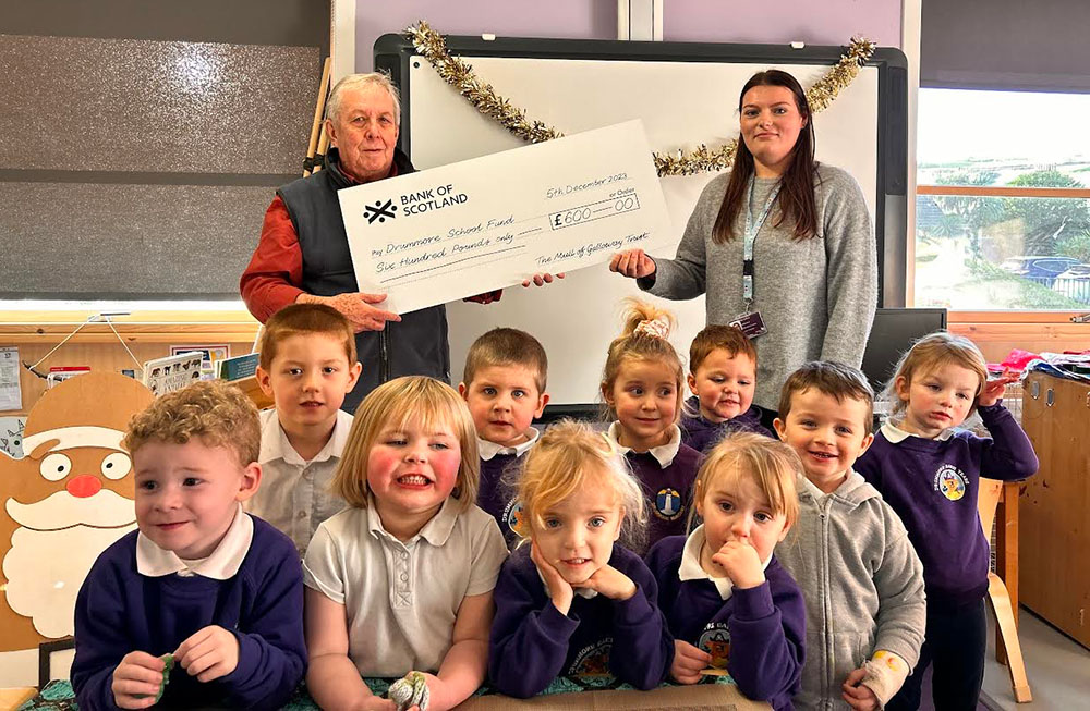 Pupils of Drummore Early Years with presentation of a cheque.